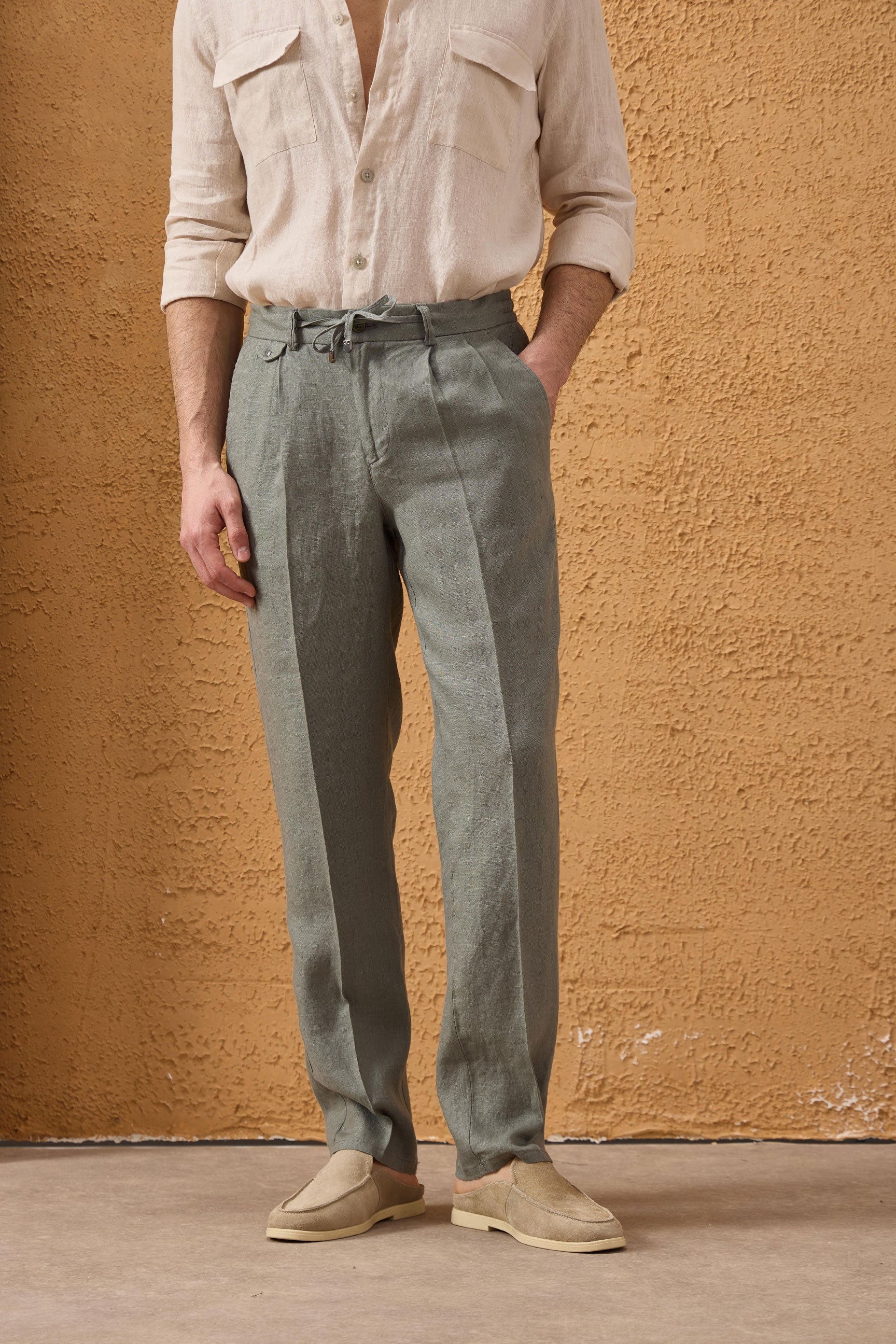 Pantaloni da uomo verde salvia in 100% lino, plissettati, con coulisse, vestibilità dritta e rilassata.