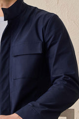 Completo da uomo elegante e casual composto da giacca safari in misto cotone blu navy e pantaloni bianchi.