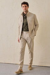 Pantaloni eleganti da uomo beige a pieghe, vestibilità classica e sartoriale.