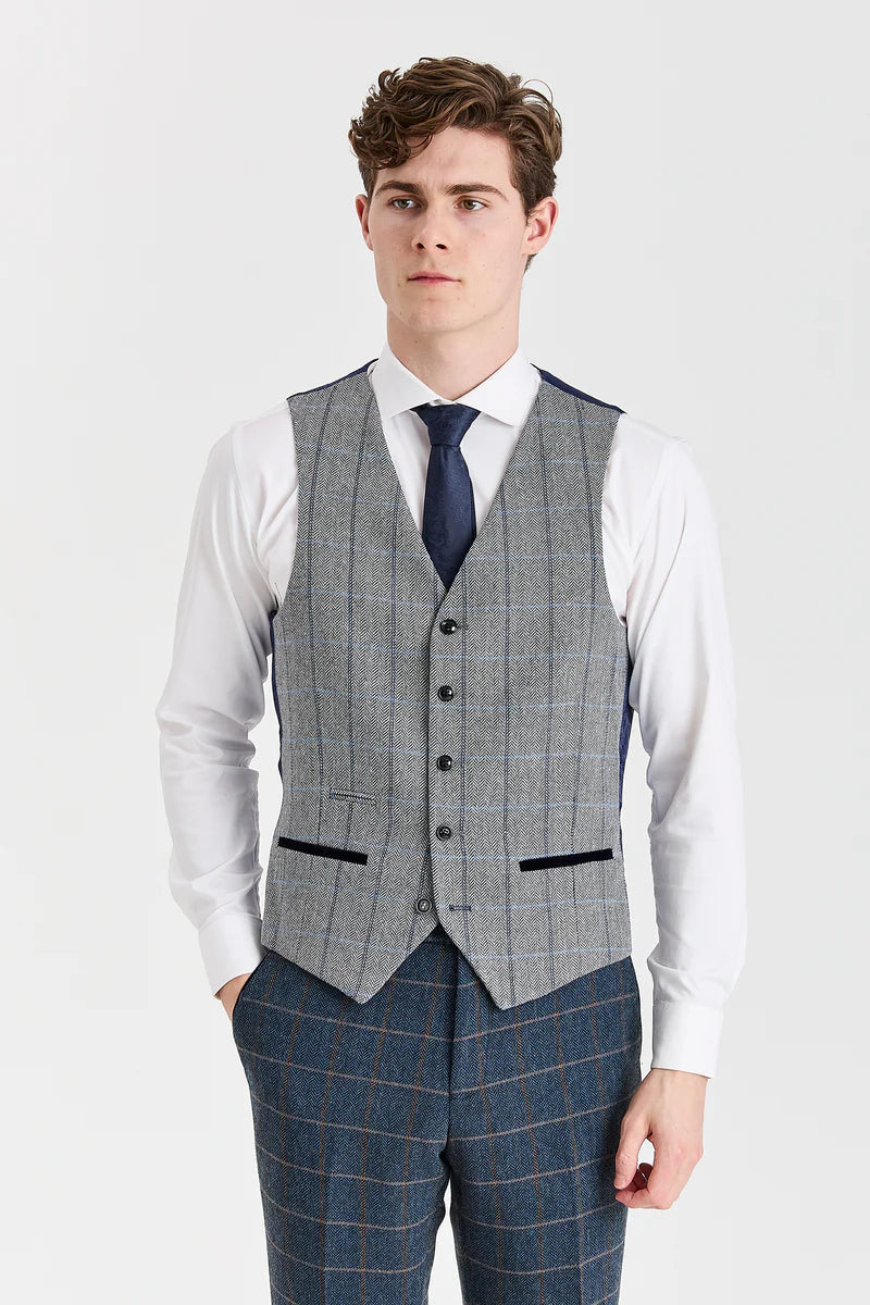 Abito Harris in tweed blu navy con gilet Harris in tweed grigio a contrasto.