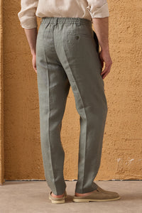 Completo estivo da uomo composto da giacca in lino blu navy con zip e pantaloni color salvia, elegante e casual.